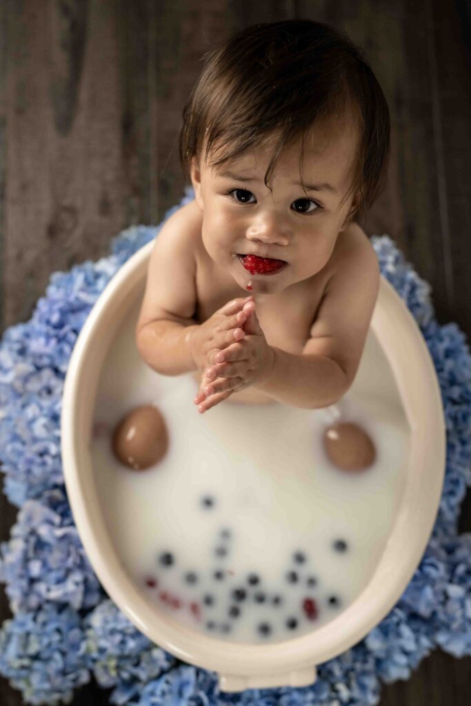 Baby M's milk bath photography session with a mouth full of raspberries. taken in my Edmonds studio.
